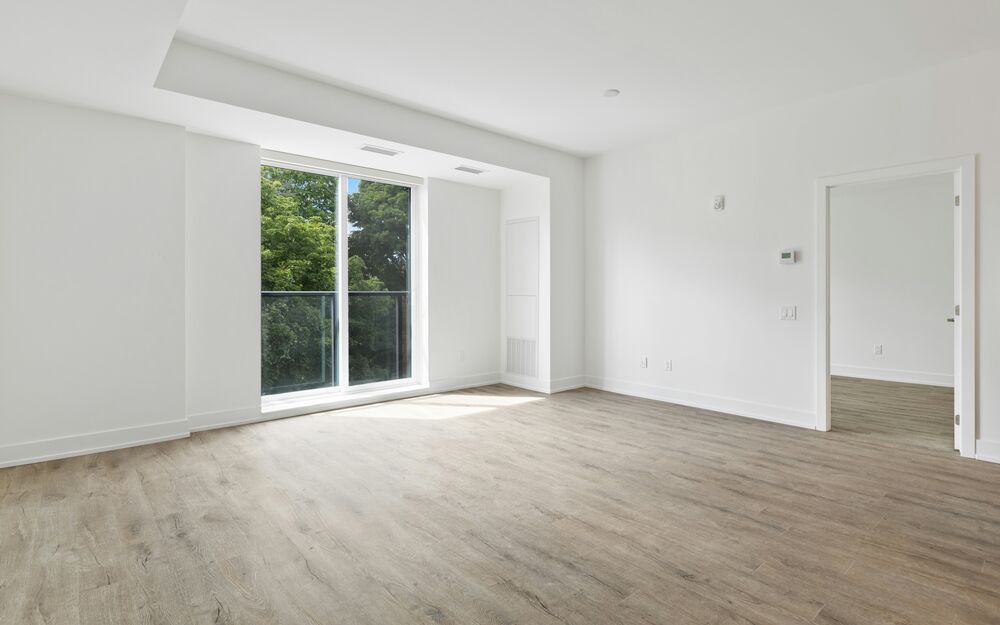 Bright, empty apartment unit with clean flooring, ready to rent